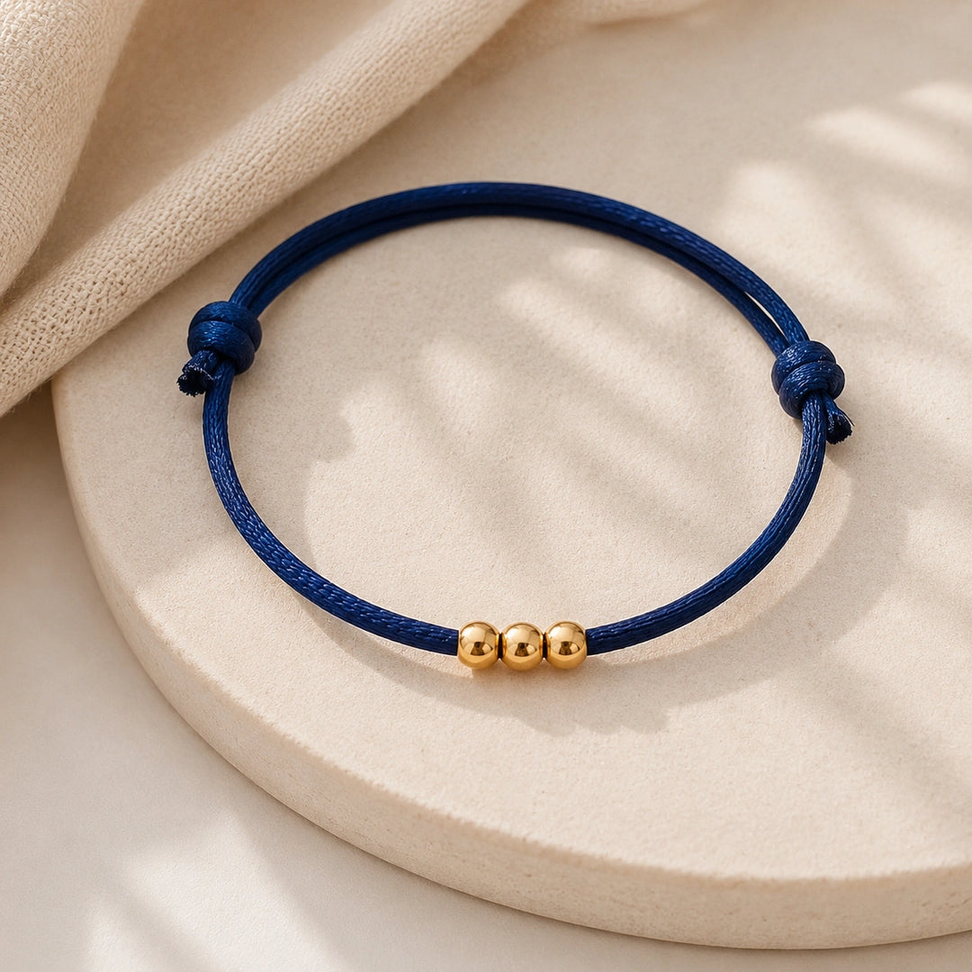Bracelet famille personnalisé avec anneaux dorés sur cordon coloré, symbole des membres de la famille